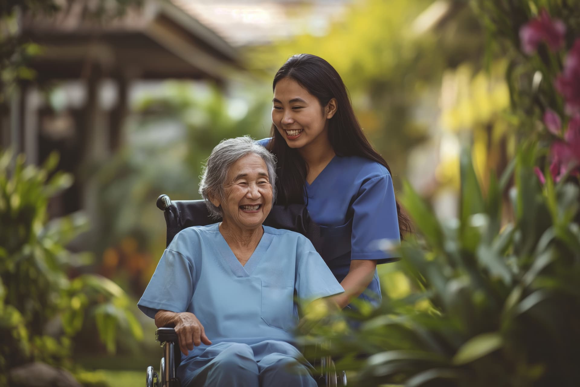 A caregiver and elderly person sharing a joyful moment together in a garden